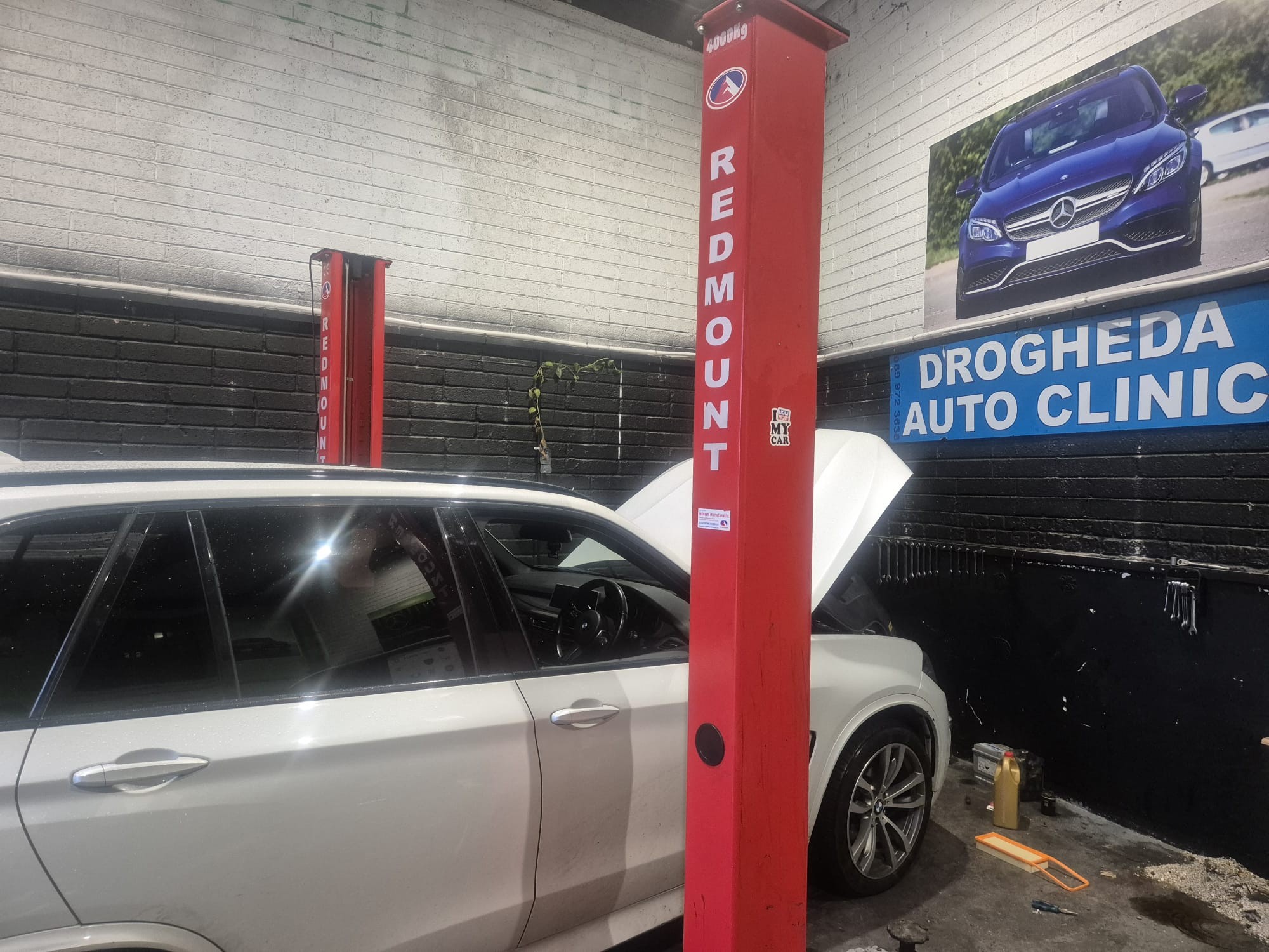 BMW X5 raised on two-post lift